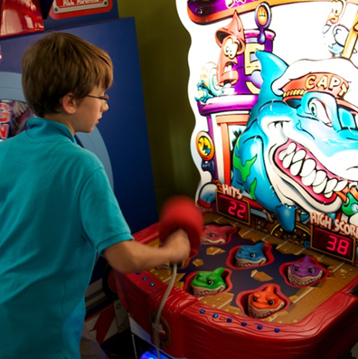 Child Playing Arcade Game